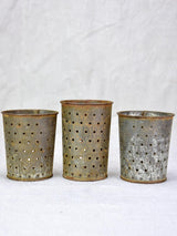 Collection of three tin cheese strainer molds / faisselles