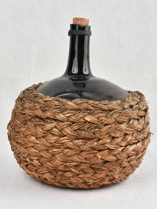 Small demijohn bottle in woven straw basket 11½"
