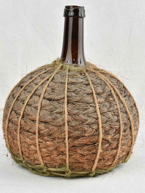 Small demijohn bottle in woven straw basket 13½"