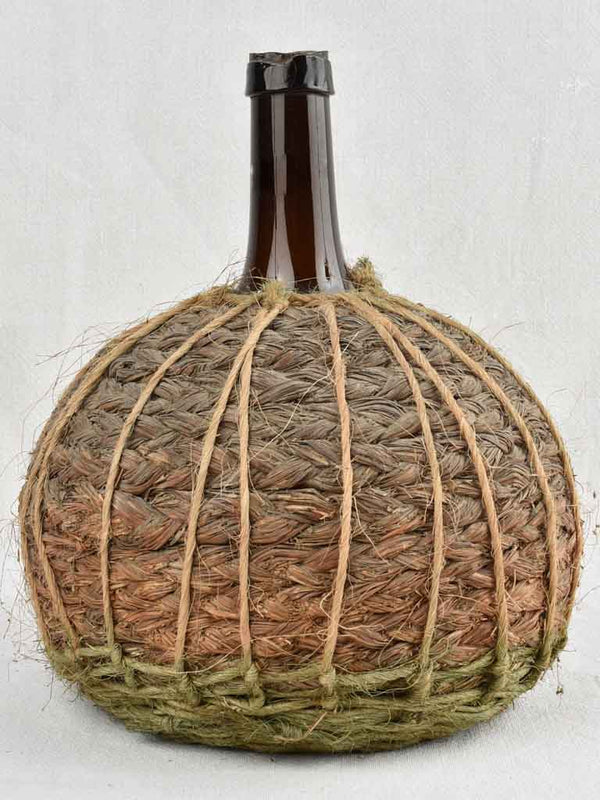 Small demijohn bottle in woven straw basket 13½"