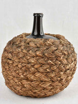 Medium demijohn bottle in woven straw basket 12½"