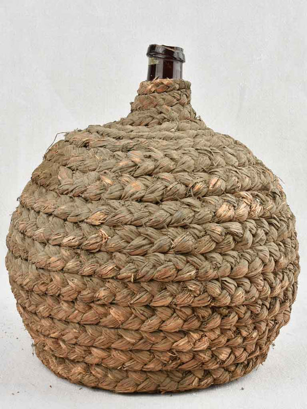 Medium demijohn bottle in woven straw basket 13¾"