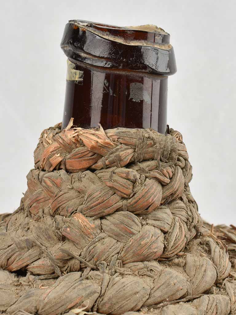 Medium demijohn bottle in woven straw basket 13¾"