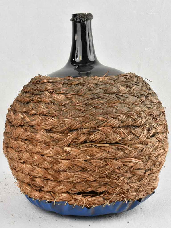 Large demijohn bottle in woven straw basket 15 ¾"