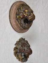 Early-century wooden-mounted lion door decorations