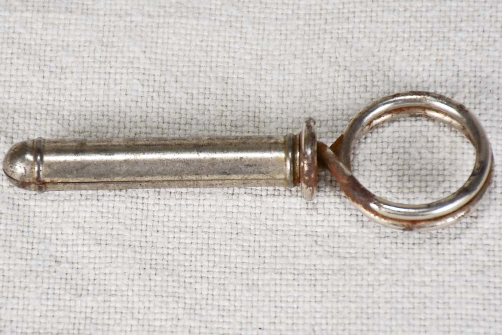 Historic cylindrical travel bottle opener photo