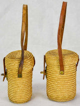 Two mid century French 'verre de cure' glasses in baskets