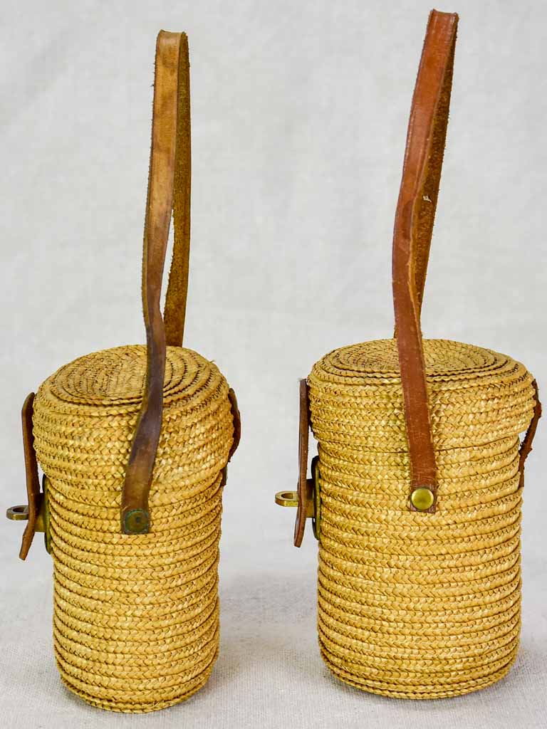 Two mid century French 'verre de cure' glasses in baskets