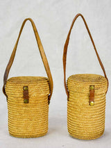 Two mid century French 'verre de cure' glasses in baskets
