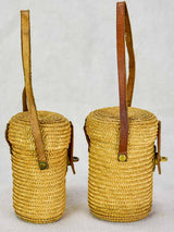 Two mid century French 'verre de cure' glasses in baskets