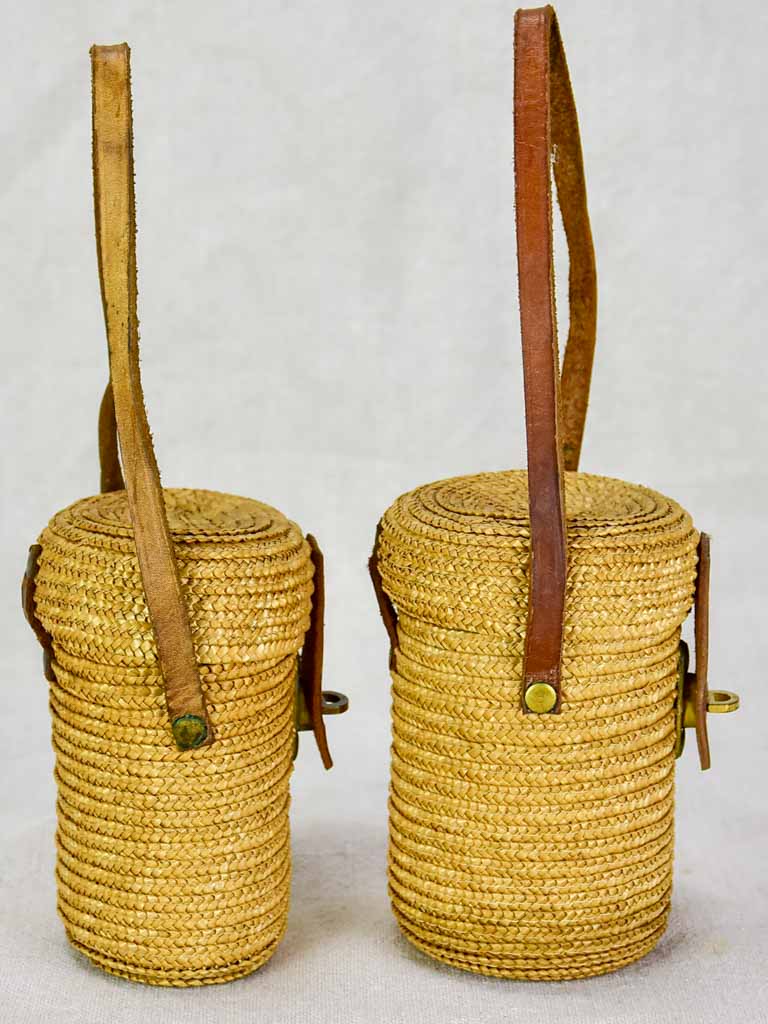 Two mid century French 'verre de cure' glasses in baskets
