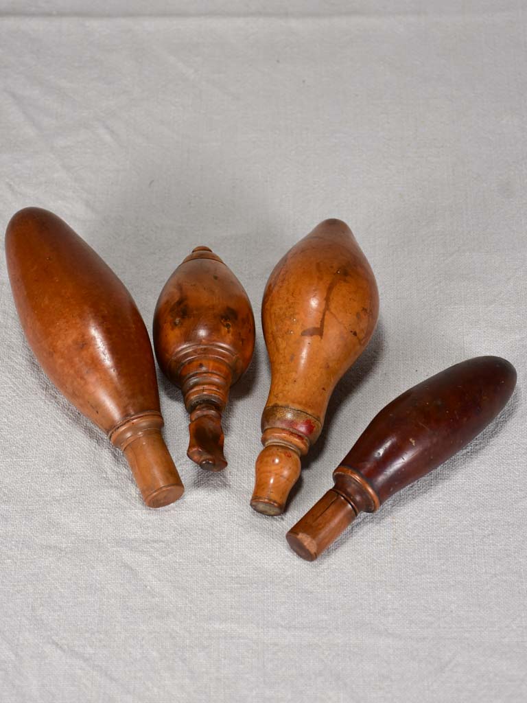 Collection of 4 early twentieth century wooden gun powder flasks