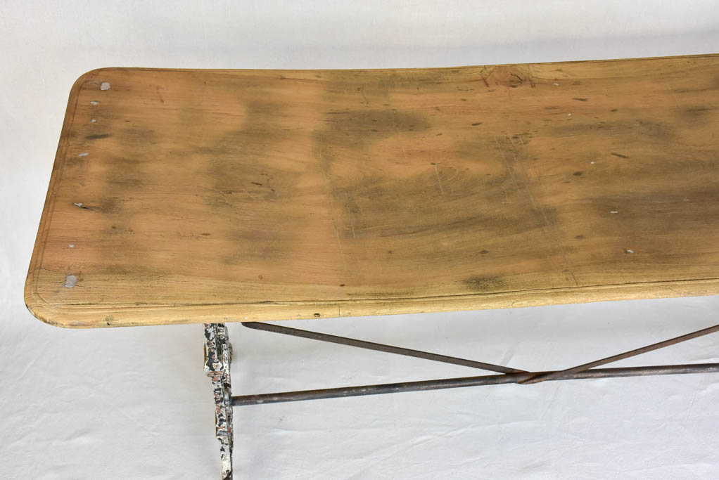Early twentieth century French bistro table with cast iron base and timber top 66¼"
