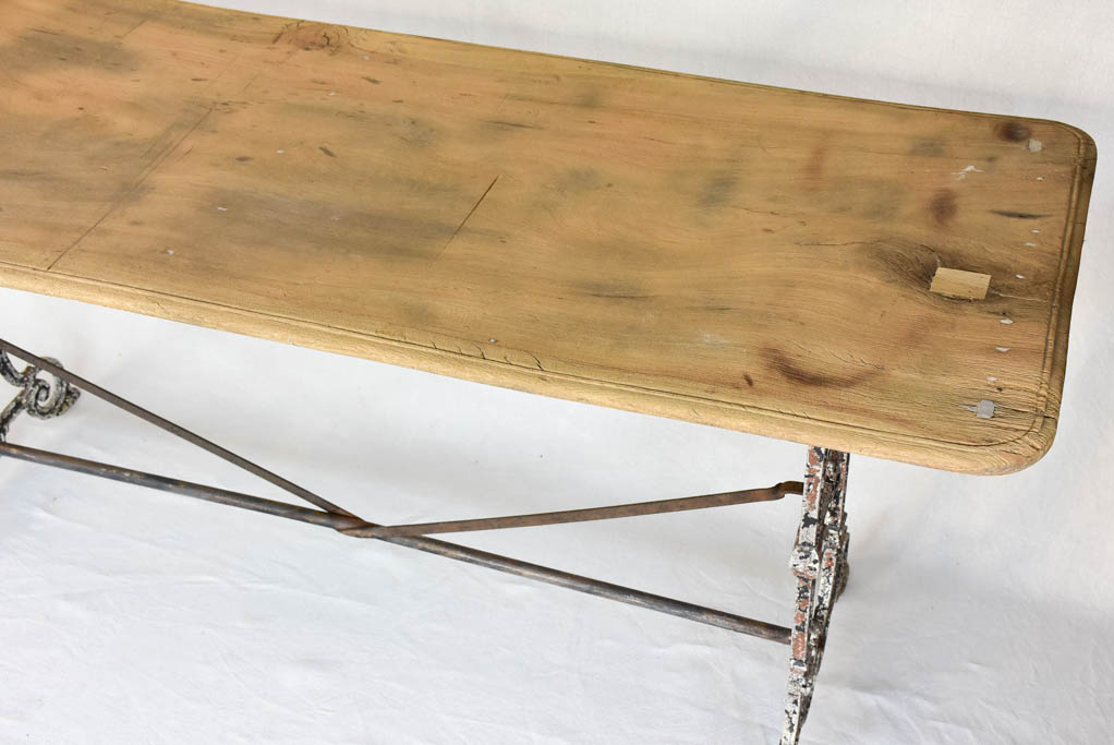 Early twentieth century French bistro table with cast iron base and timber top 66¼"
