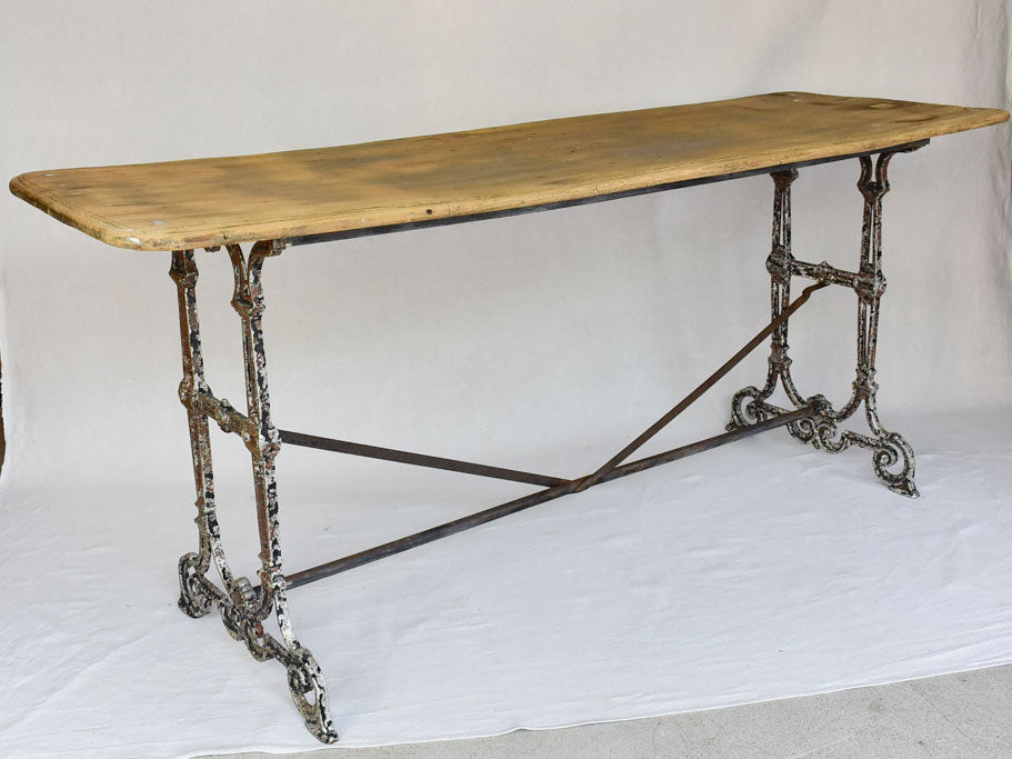 Early twentieth century French bistro table with cast iron base and timber top 66¼"