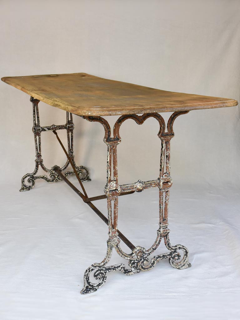 Early twentieth century French bistro table with cast iron base and timber top 66¼"