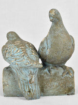 Vintage garden sculpture of two pigeons on a log