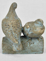 Vintage garden sculpture of two pigeons on a log