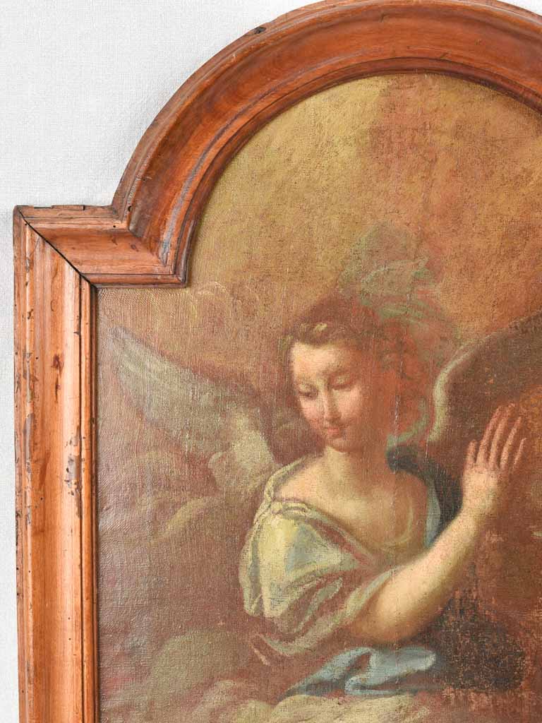 17th century painting of an angel in prayer in arched wooden frame 24" x 27¼"