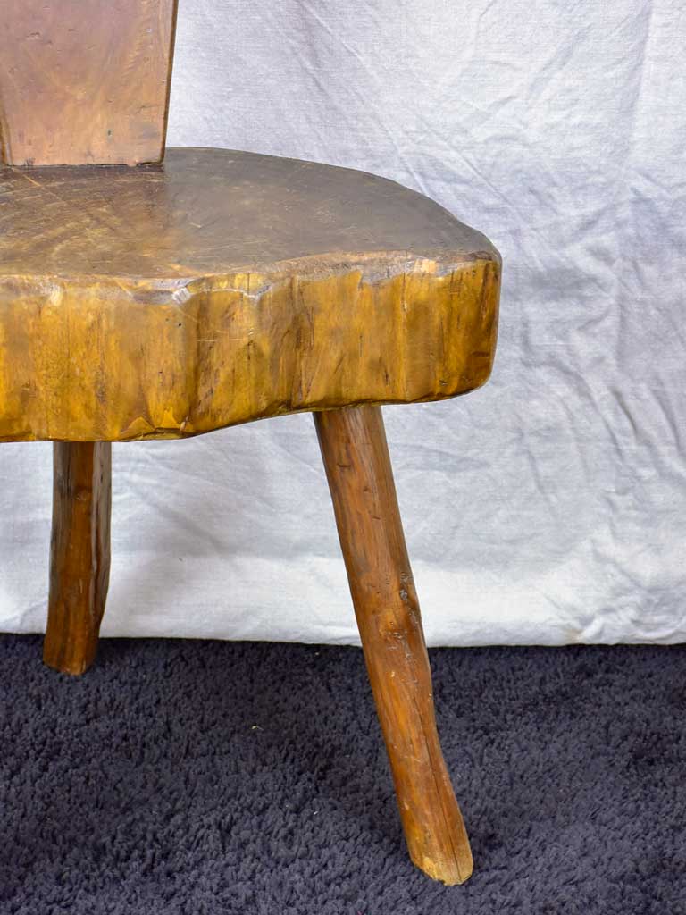 Antique primitive milking chair with three legs and teardrop back