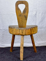 Antique primitive milking chair with three legs and teardrop back