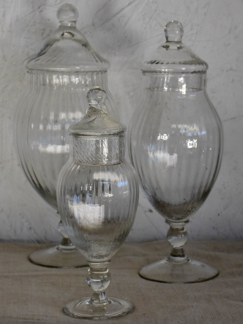 Three vintage French glass vanity jars with lids