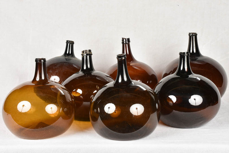Rare collection of 9 blown glass demijohn bottles 12¼" - 22¾"