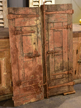 Pair of antique French shutters with original hardware and red patina