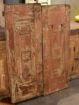 Pair of antique French shutters with original hardware and red patina