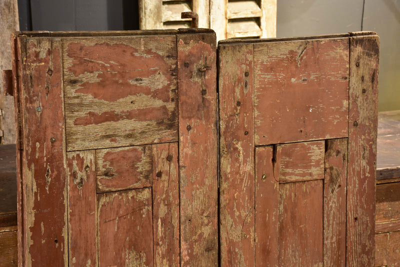 Pair of antique French shutters with original hardware and red patina