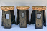 Three 1960's stools with woven seats and weighty timber and iron bases