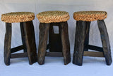 Three 1960's stools with woven seats and weighty timber and iron bases