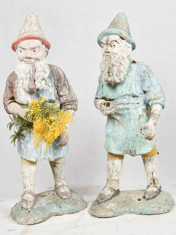 Two charming 1930's garden gnomes with hands positioned to display floral bouquets 37½"