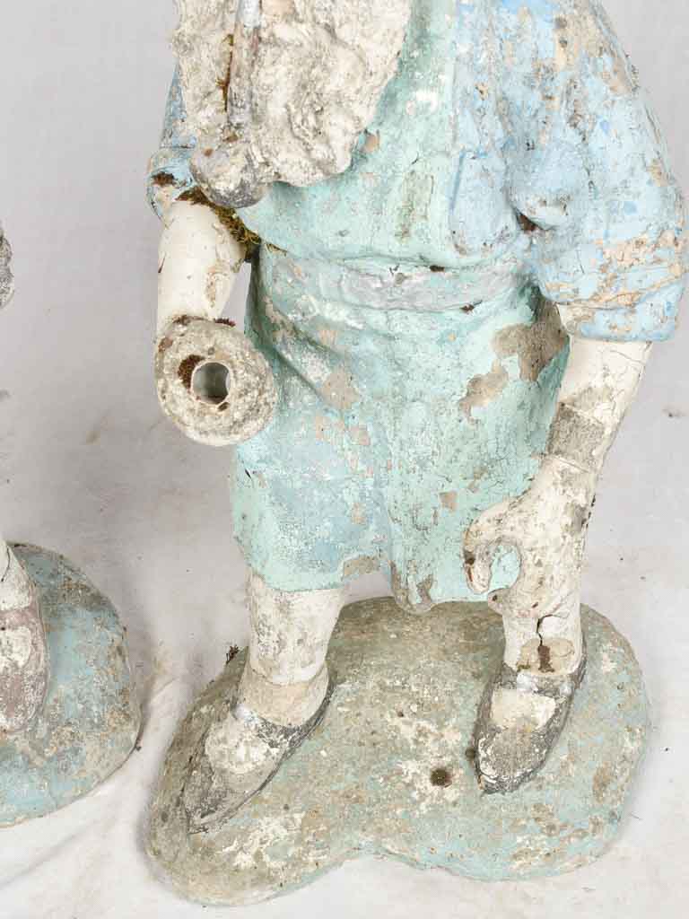Flower-holding timeworn garden statues