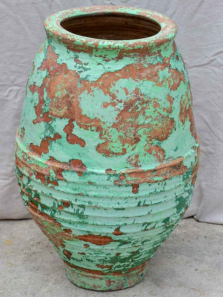Very large antique Spanish olive oil jar with green patina