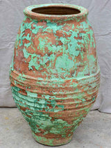 Very large antique Spanish olive oil jar with green patina