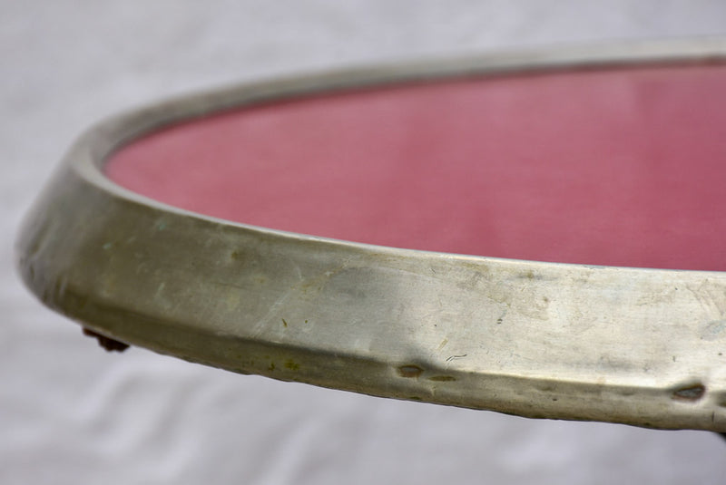 Art Nouveau cast iron bistro table with red glass table top
