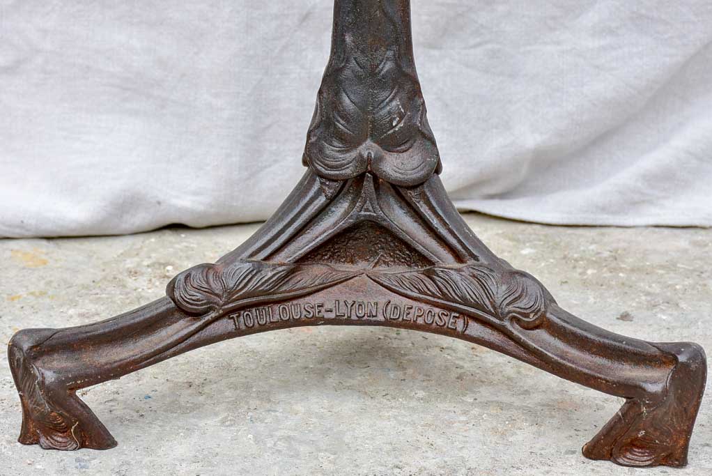 Art Nouveau cast iron bistro table with red glass table top