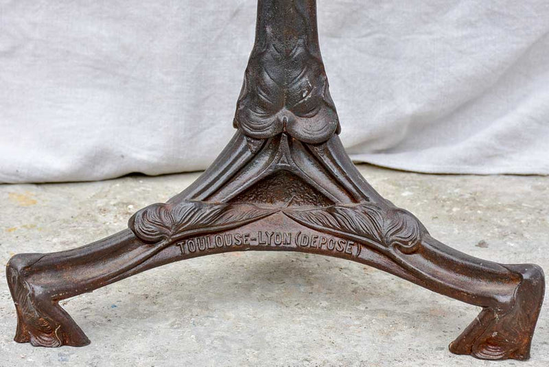 Art Nouveau cast iron bistro table with red glass table top