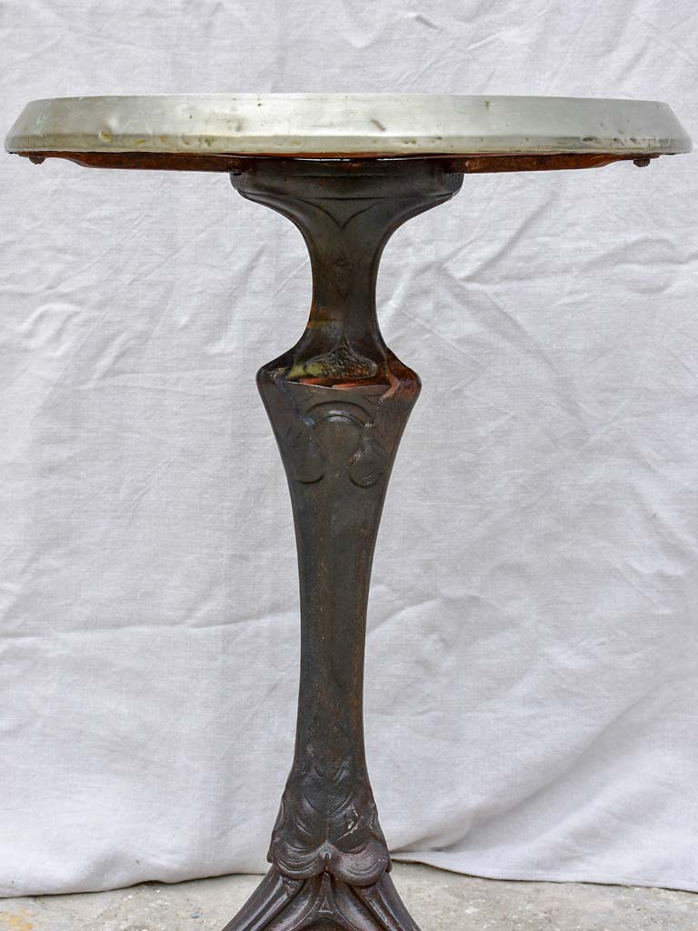 Art Nouveau cast iron bistro table with red glass table top