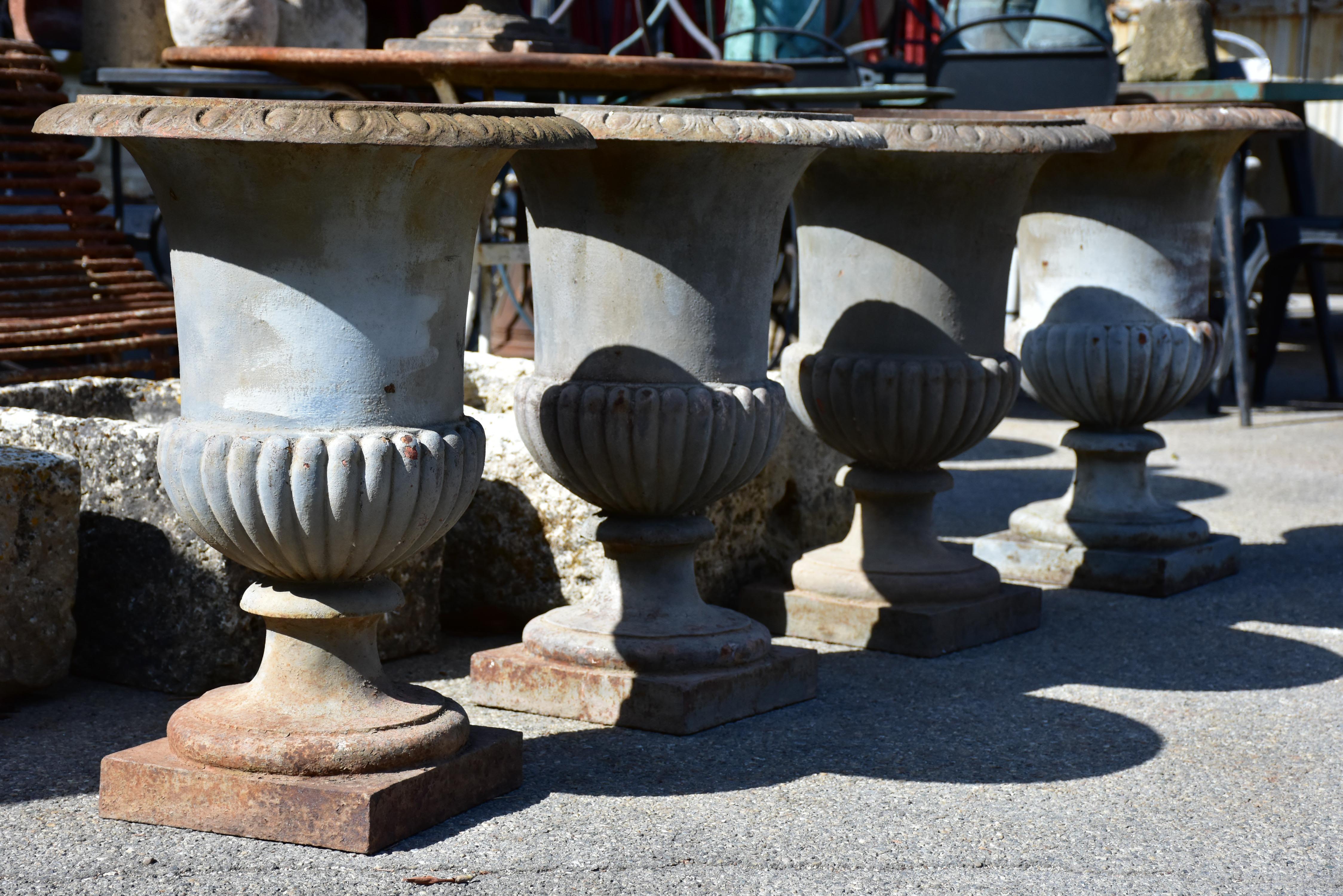 Collection of four cast iron medici urns from the 19th century