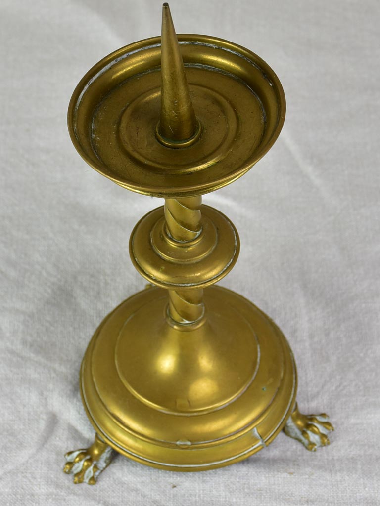 Gold-tinted stylish claw-foot candlestick
