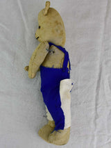 Decorative vintage teddy bear, blue overalls