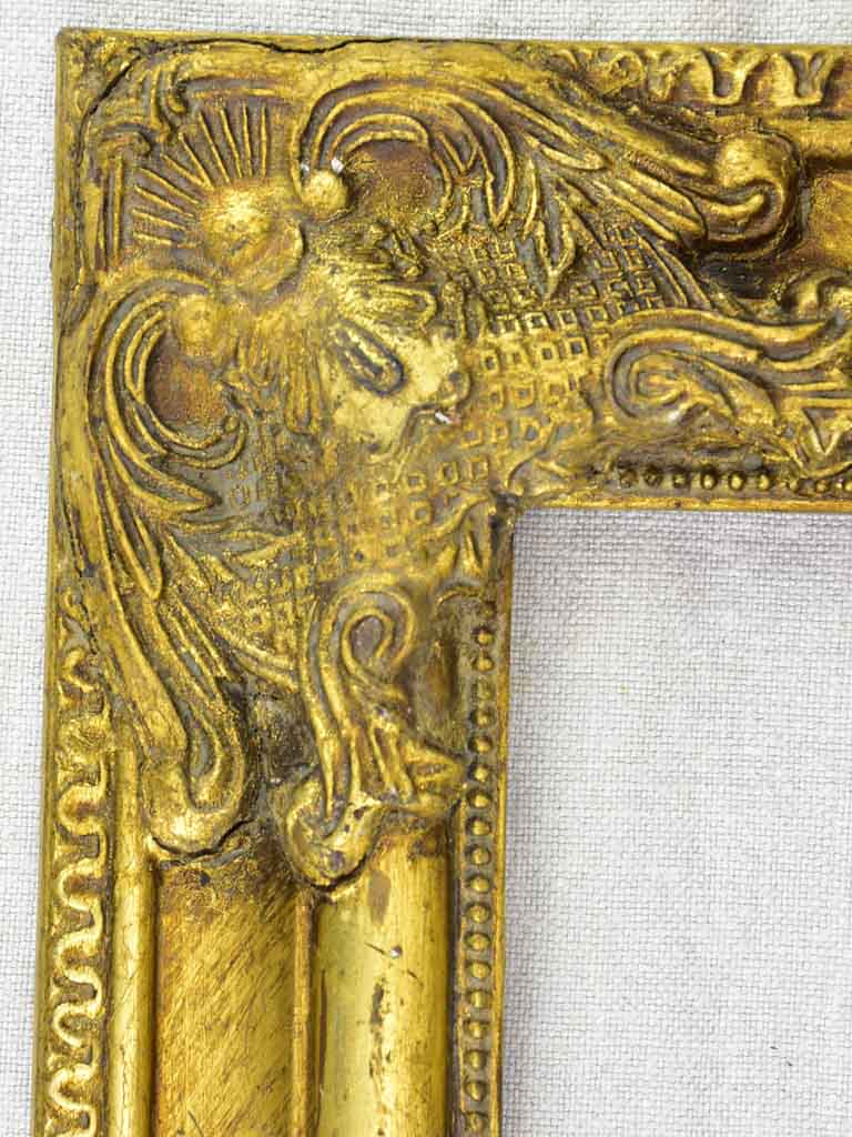 Timber and stucco frame with gold patina