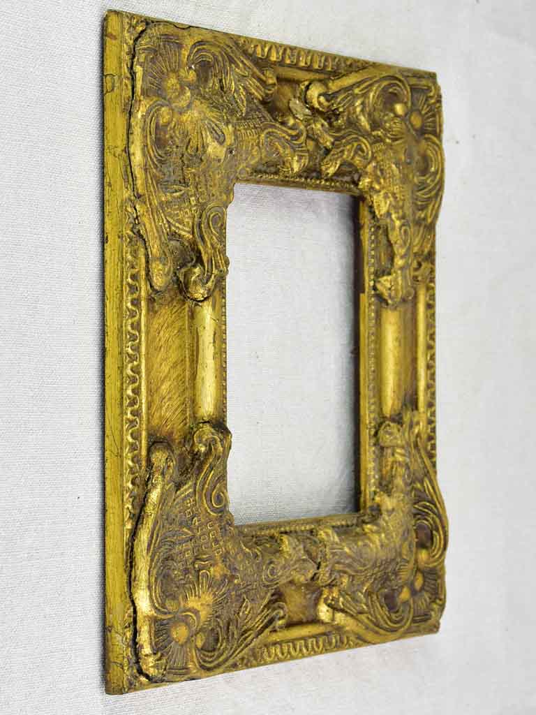 Timber and stucco frame with gold patina