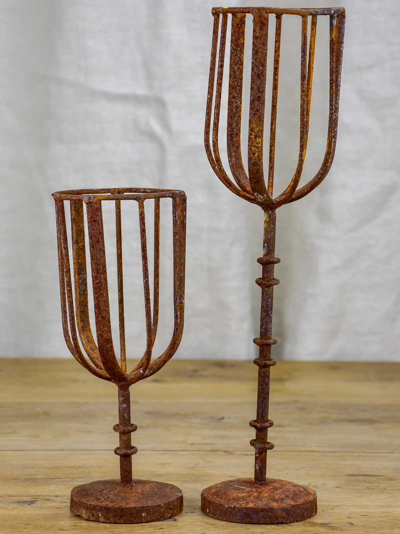 Pair of cup-shaped rustic candlesticks
