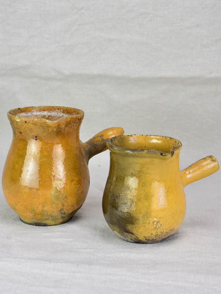 Two small antique French sauce pitchers with side handles