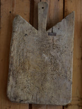 Antique French cutting board with repairs and angled corners