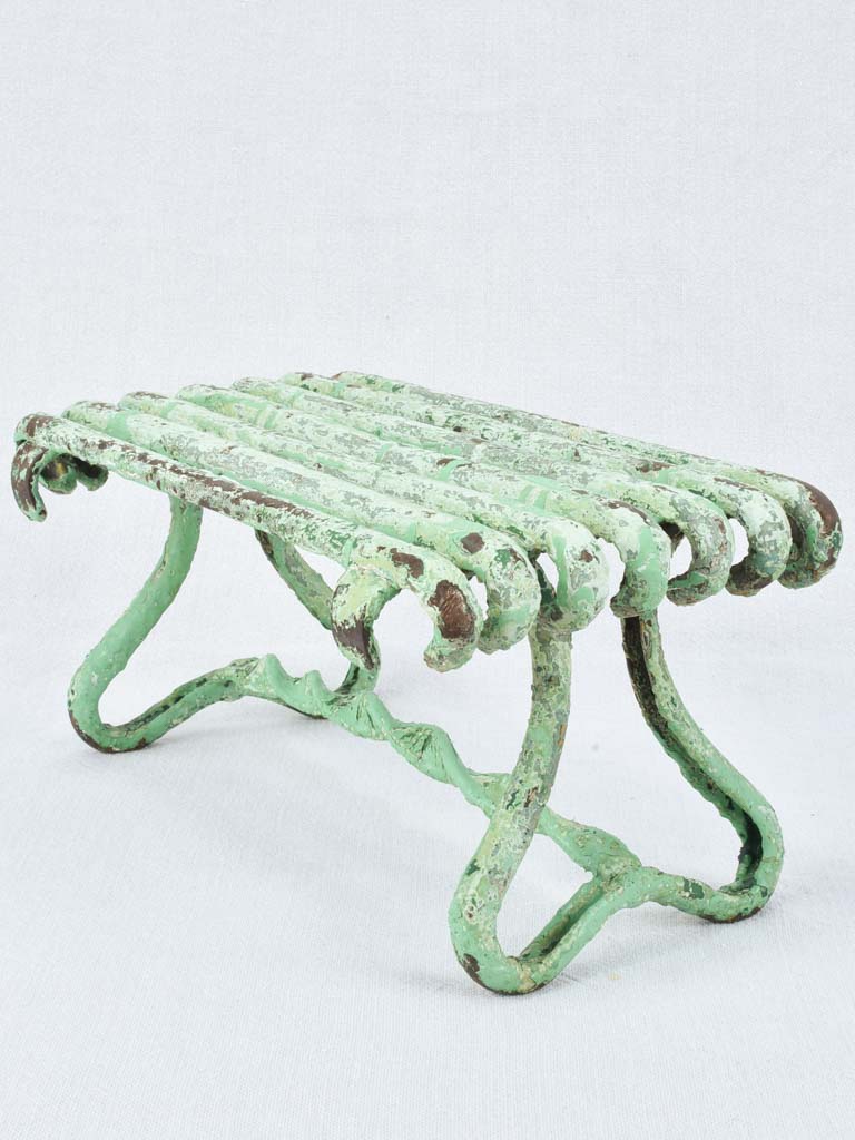 Antique garden footrest with green patina