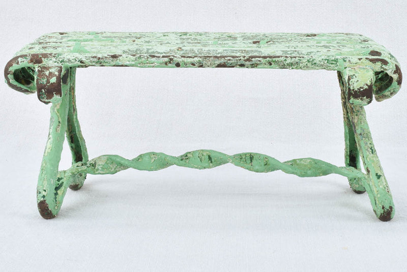 Antique garden footrest with green patina